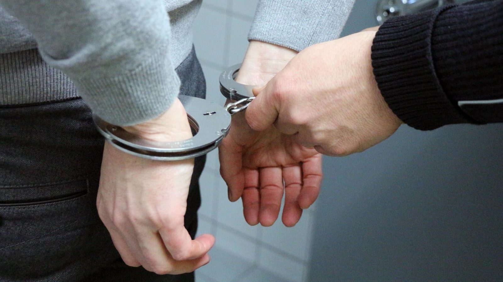 officer arresting an offender with handcuffs