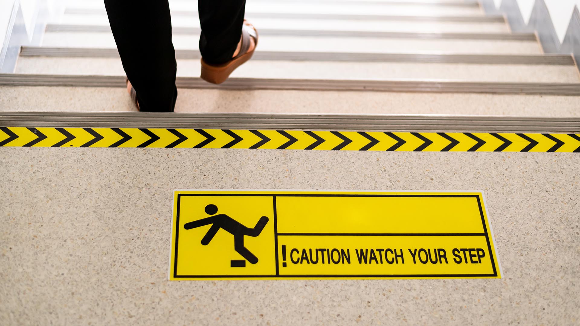 warning sign at the top of stairs