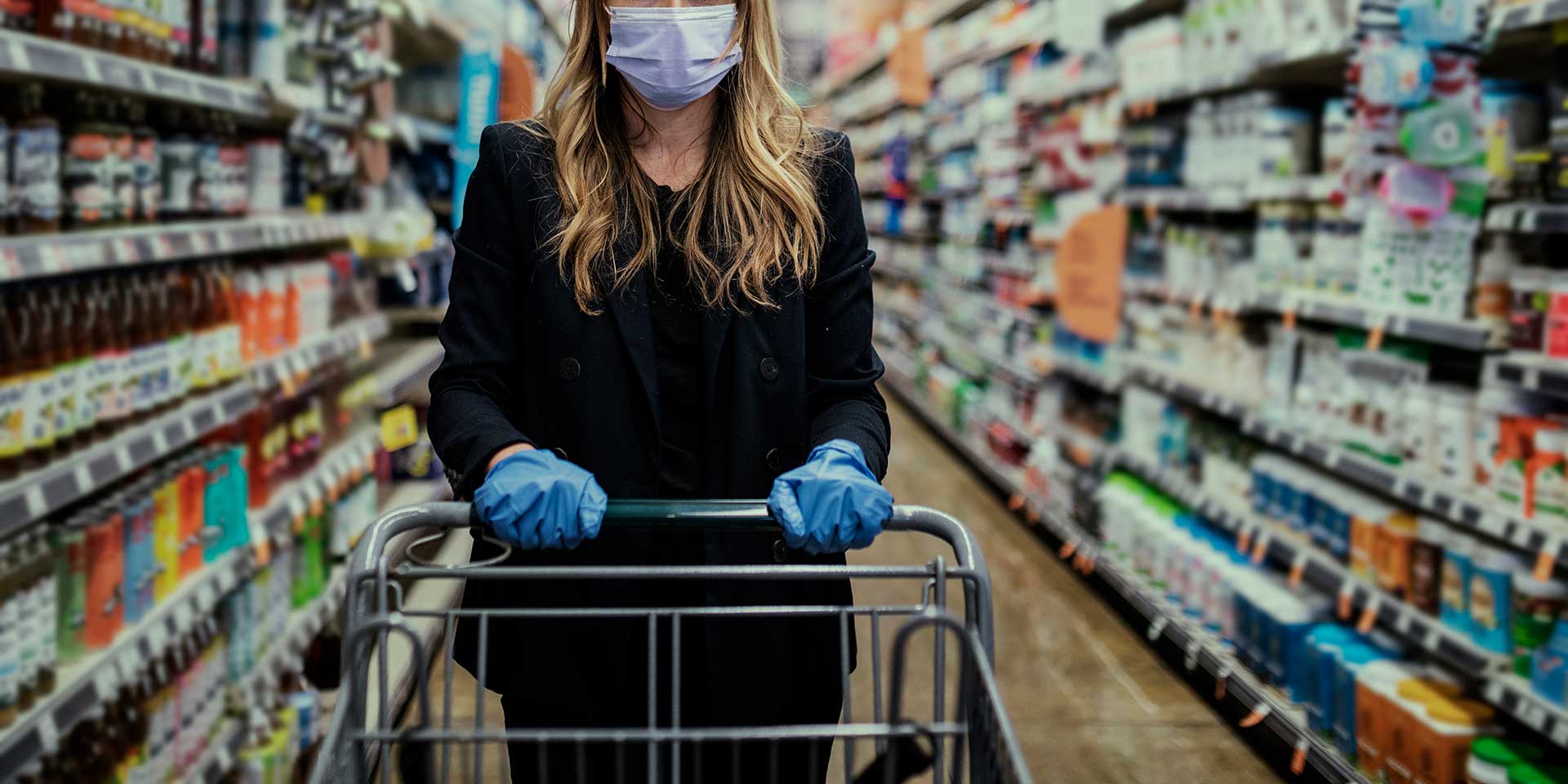 Woman wearing face mask in grocery store